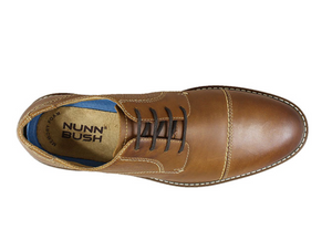 The Nunn Bush Pasadena Cap Toe Oxford features a classic cap toe with modern design details like contrast stitching, mixed textures, and a cool blue-lined midsole. To add comfort to the equation, it also has a molded Memory Foam footbed and a Casual Flex sole for unparalleled comfort.